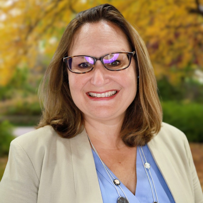 Headshot of Tricia Taylor-Oliveira.